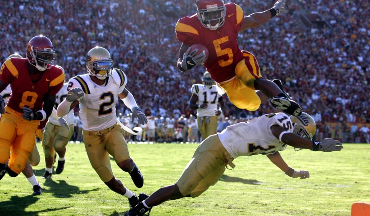 DECEMBER 3, 2005  LOS ANGELES, CA
USC's Reggie Bush leaps over UCLA's Marcus Cassel to score a touchdown in Los Angeles.